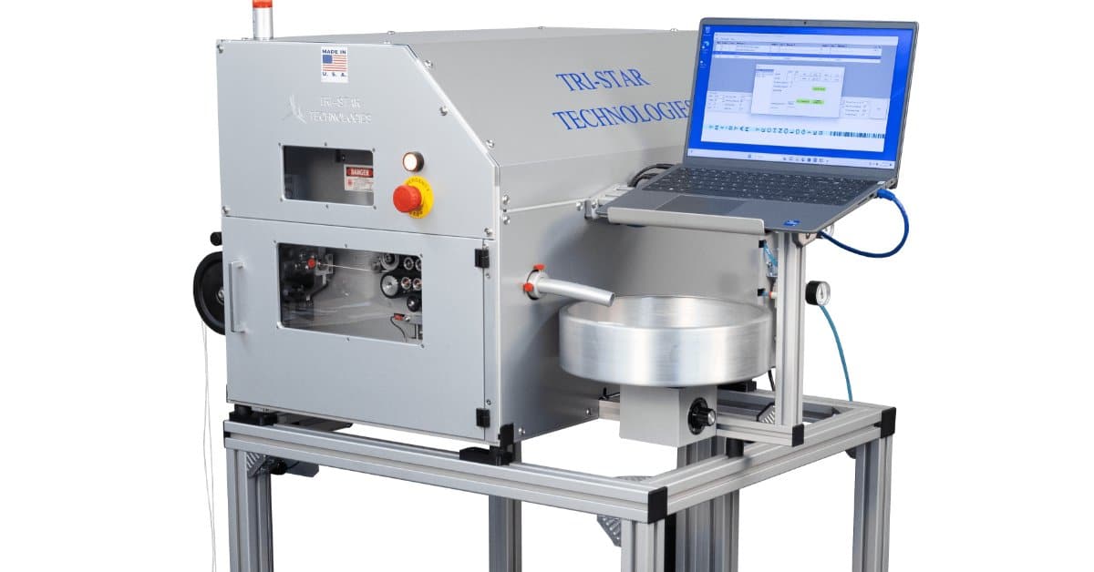 The Tri-Star Technoogies laser marking system on a roll cart with a laptop attached to it against a blank background.