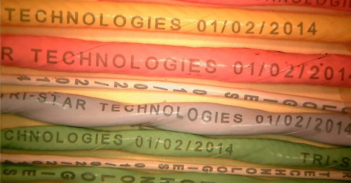 Bundle of color-coded electrical wires printed with identification information, enabling organized cable management and efficient system maintenance.